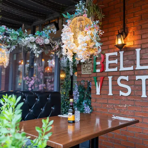 Bella Vista's flower-dressed terrace beside the red-brick lettering, Bristol