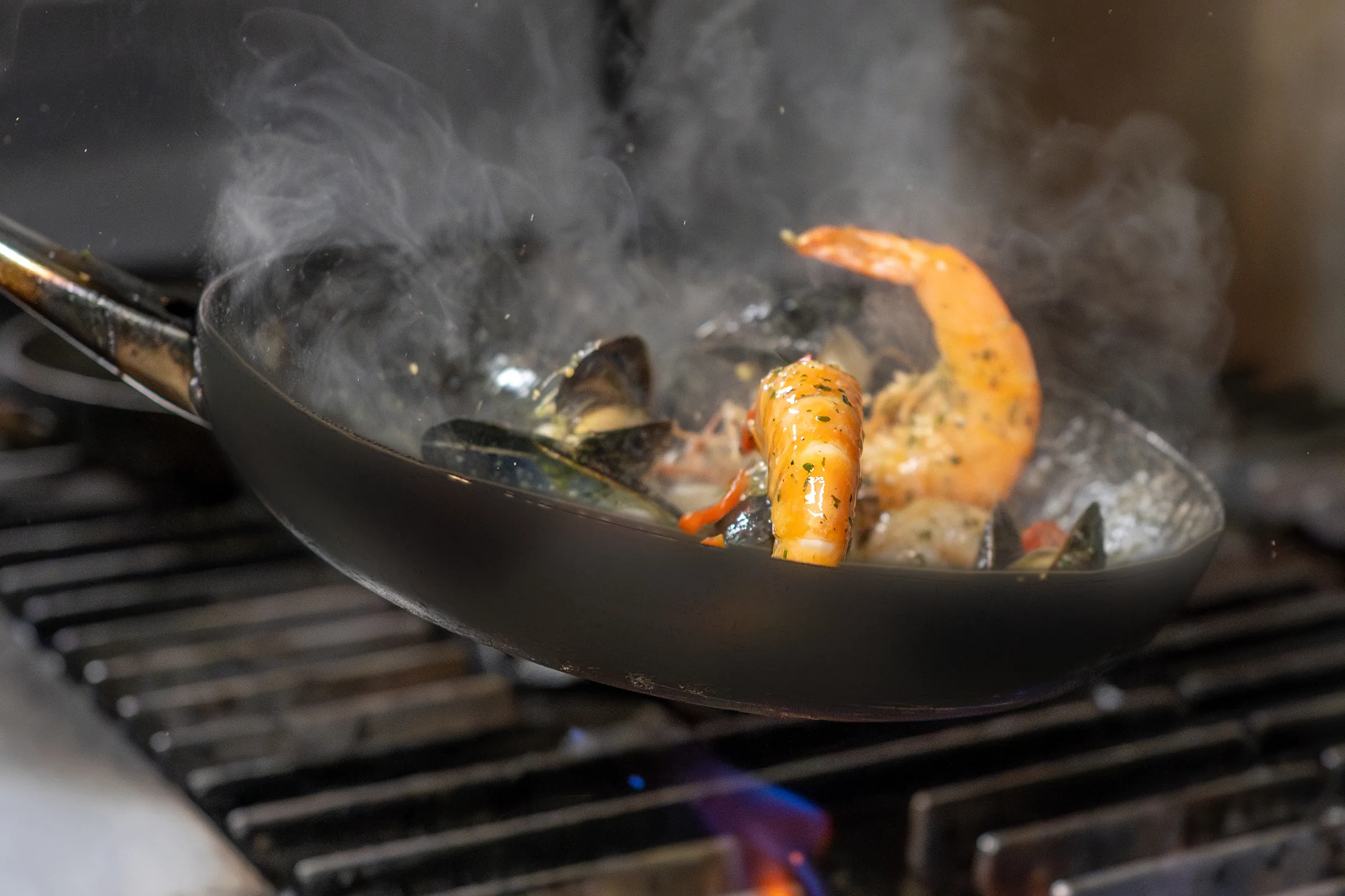 King prawns and mussels cooking in a pan over the flame at Bella Vista, Bristol